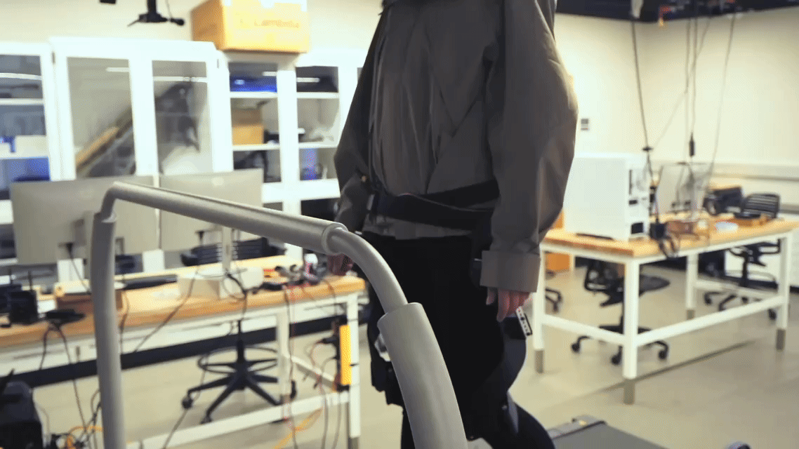 College of Engineering student Manaen Hu walking with a prototype exoskeleton on a treadmill.