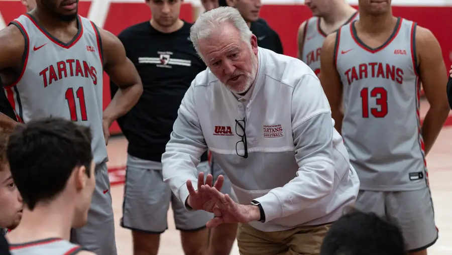Tony Wingen, head Men’s basketball coach, talks to his team during a timeout.