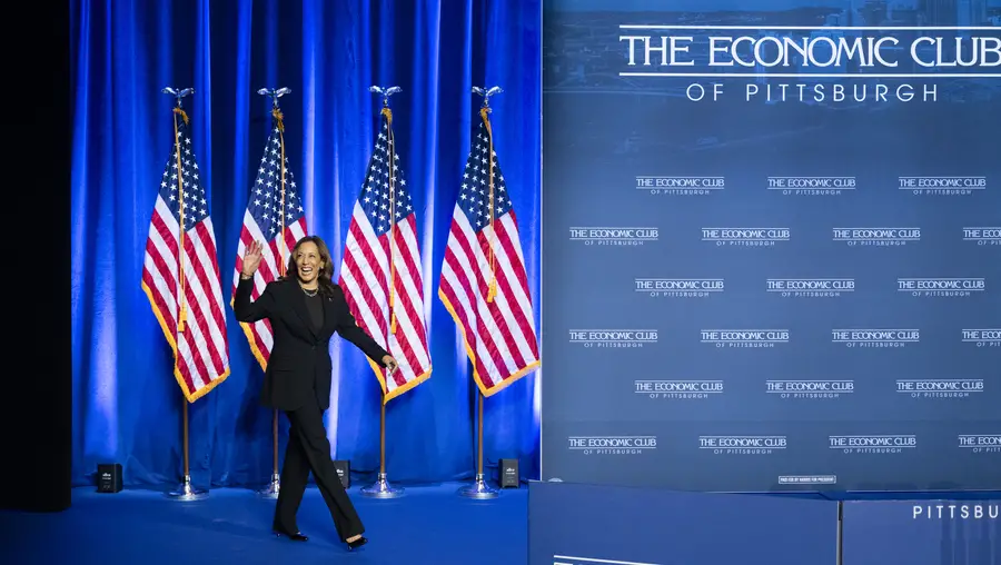 Kamala Harris in front of American flags at Carnegie Mellon.