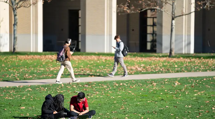 Students sitting on Carnegie Mellon's campus.